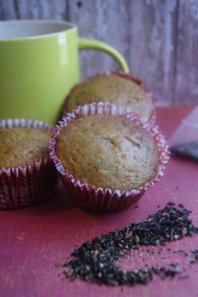 chai apple muffins on purple napkin with yellow tea mug behind