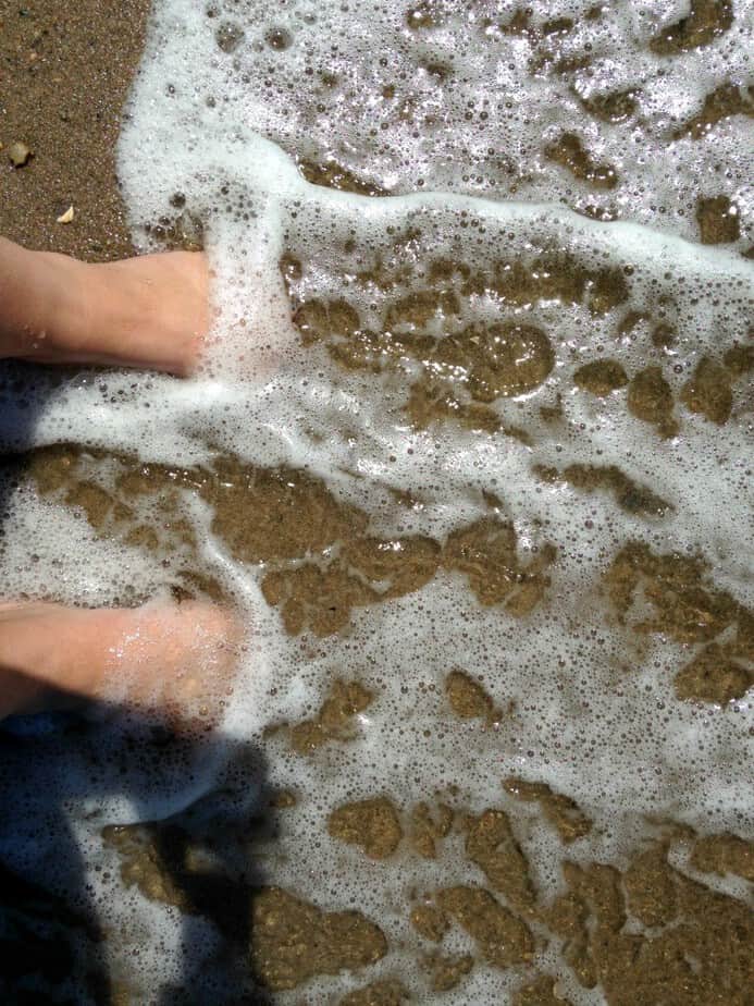 toes in water in sand 