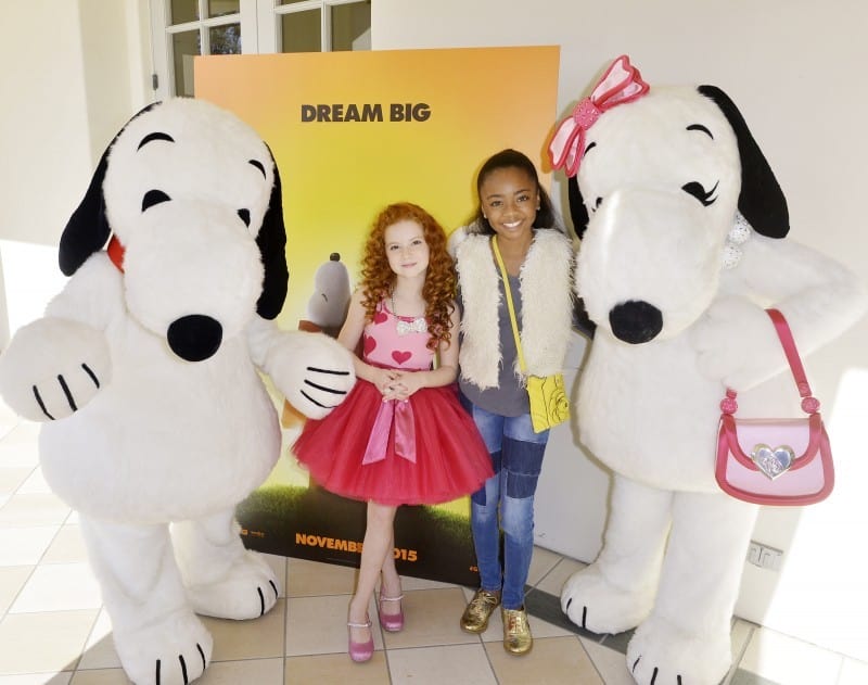 Doggone Adorable: Snoopy and his fashionista sister Belle joined Francesca and Skai Jackson from Disney’s “Jessie” for a shot in front of the new Peanuts Movie poster displayed at the party.