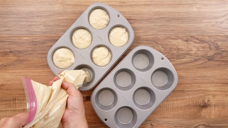 Pancake batter in bag piping into muffin tins