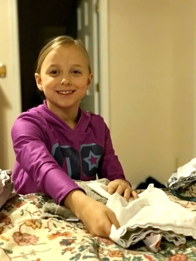8 year old helping fold laundry kid helping fold laundry