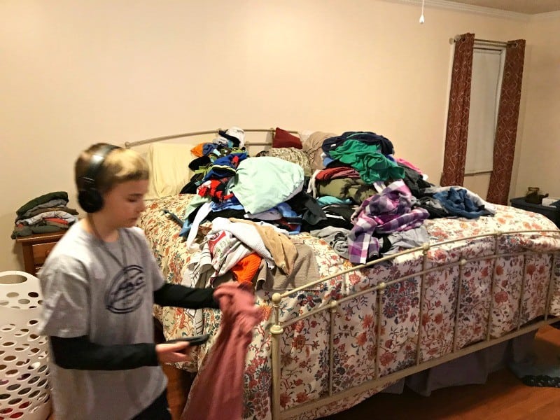 reasons for kids to help do laundry- 10 year old helping to sort laundry