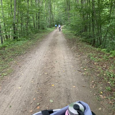 mom biking behind kids on trail