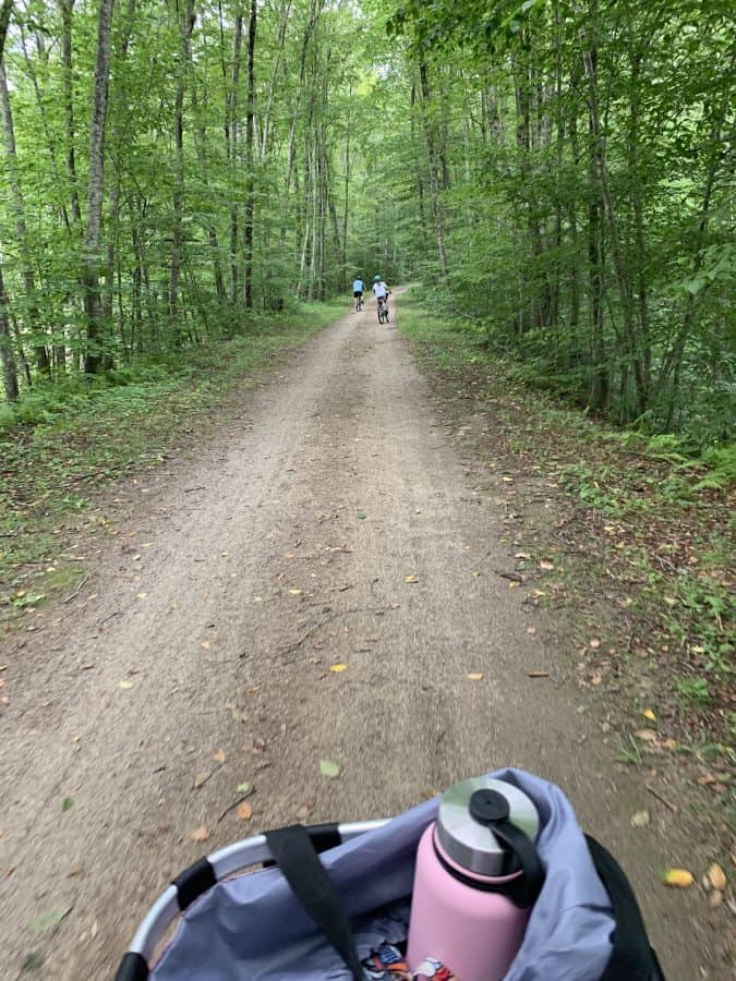 mom biking behind kids on trail