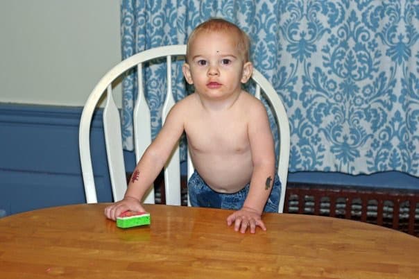 toddler cleaning kitchen table
