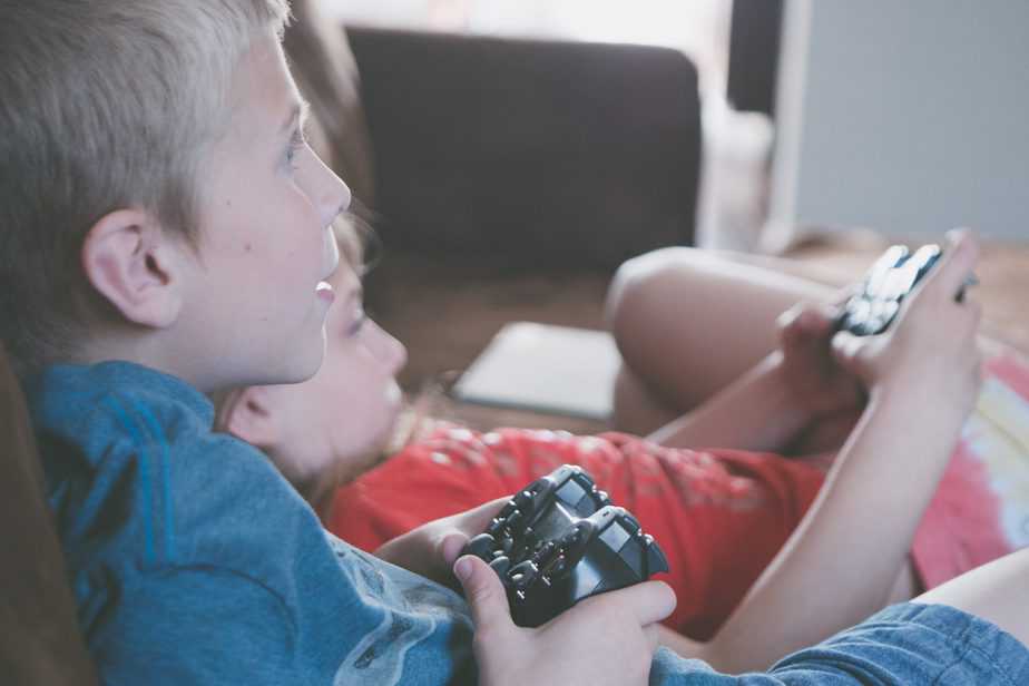 two-boy-and-girl-holding-game-controllers