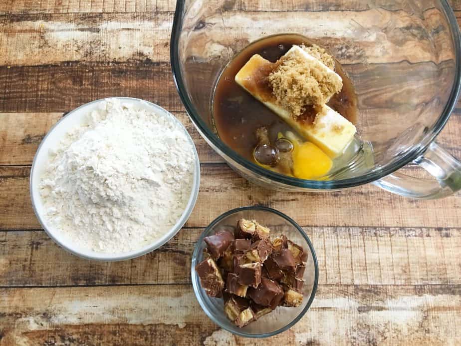 Snickers cookies ingredients in glass mixing bowl 