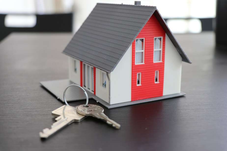 small grey and red house with two keys