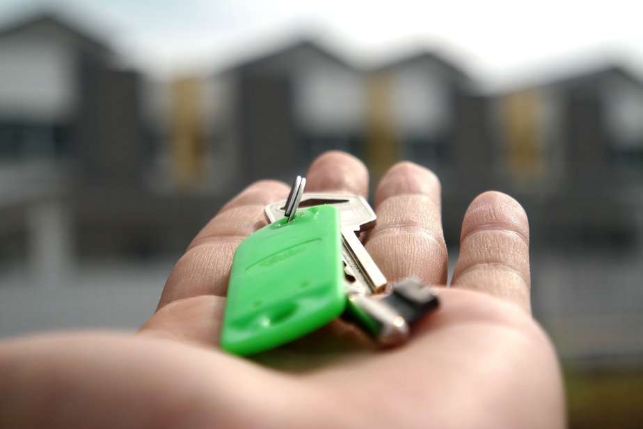 keys on green keyring in outstretched hand 