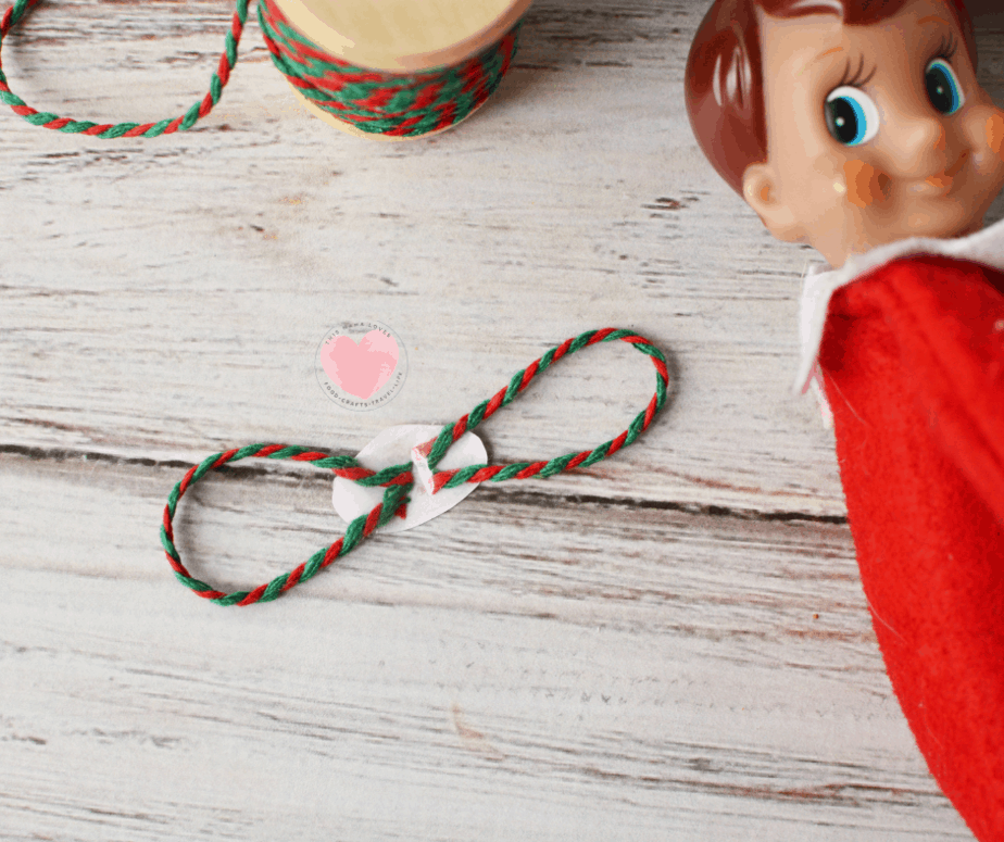 assembling elf on the shelf sized mask with red and green yarn