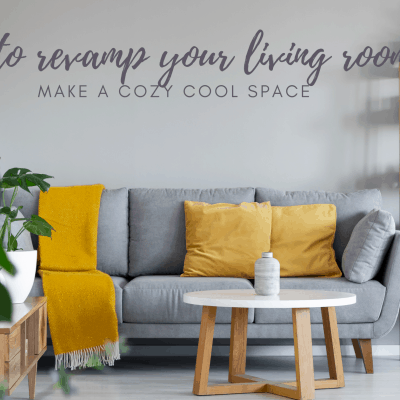 grey couch with mustard cushions in front of grey accent wall