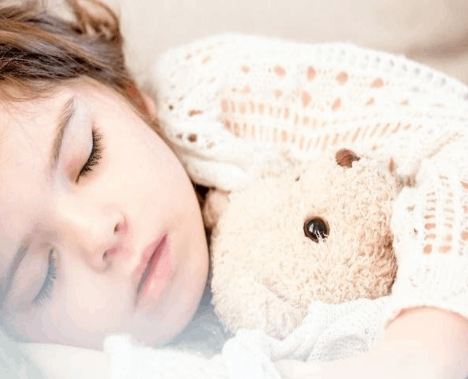 close up toddler sleeping with stuffed animal
