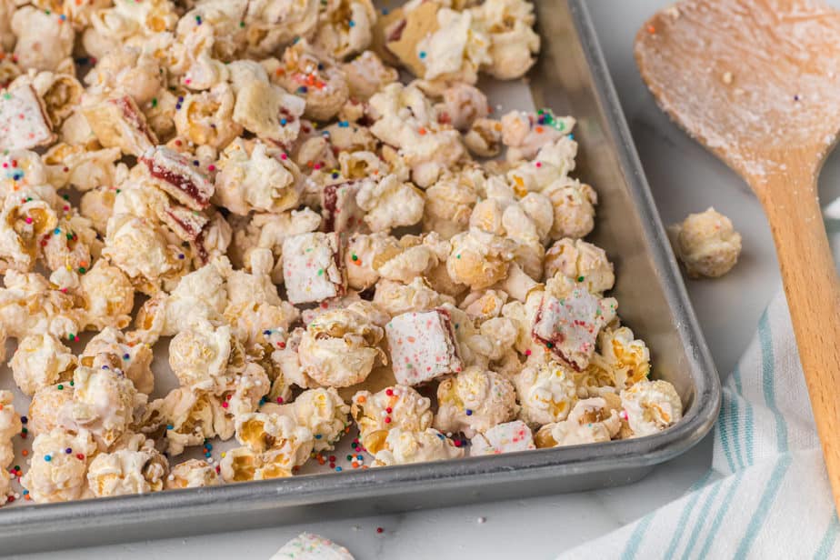 strawberry glazed popcorn mix on baking sheet