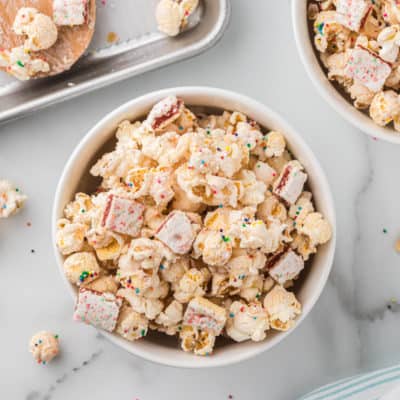 white bowl filled with strawberry glazed popcorn mix