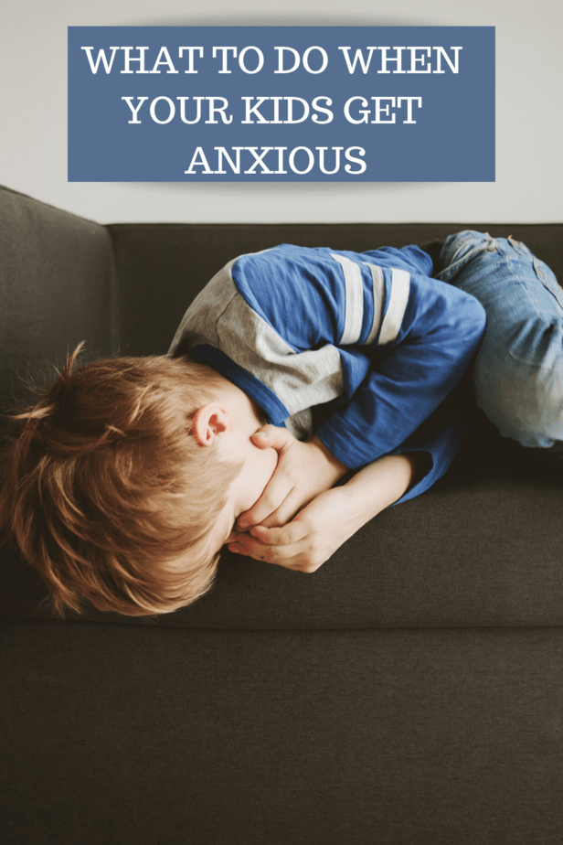 boy curled up on couch hiding face