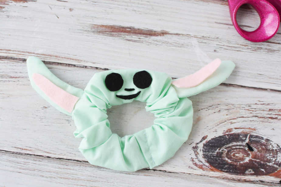 homemade baby yoda scrunchie laying flat on white background