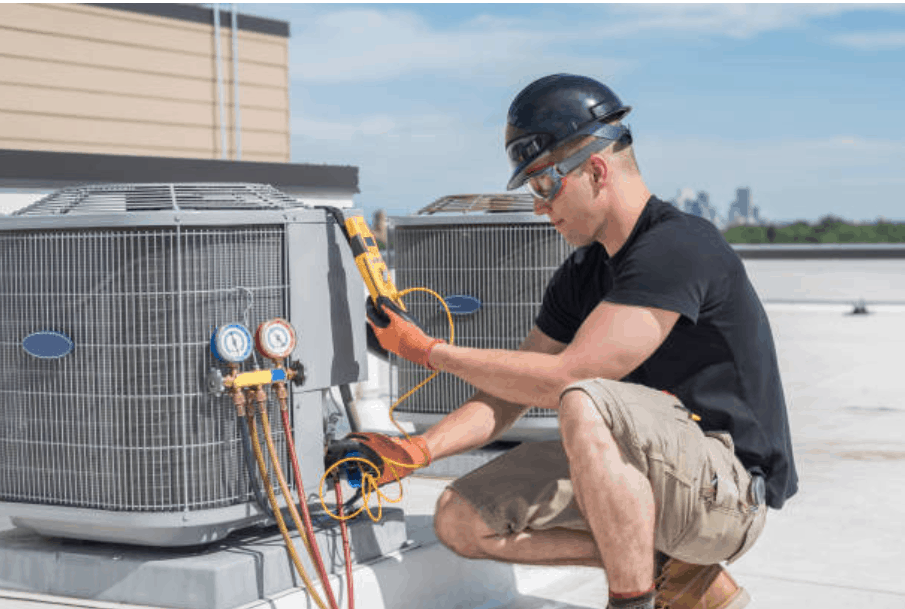 man in hard hat testing hvac unit 