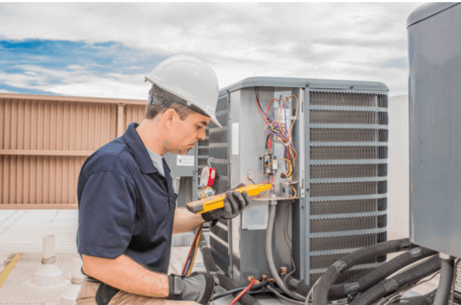 man in hard hat working on hvac unit