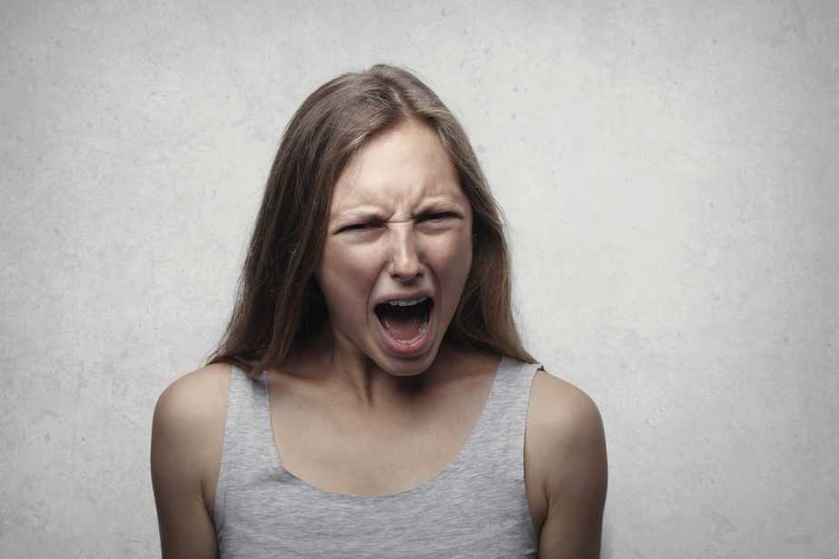 woman in grey tank shouting