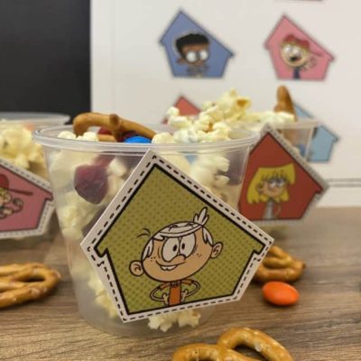 Snack mix in clear plastic cup with cutout image of Lincoln Loud from Nickelodeons the loud house taped to front