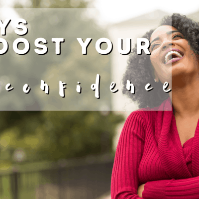 black woman outdoors with red top laughing