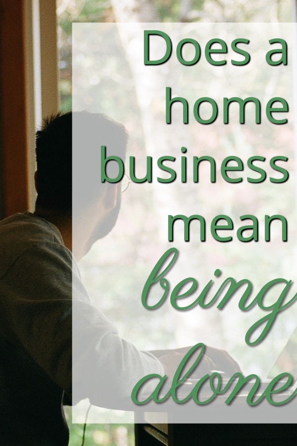 man working at home on laptop looking out window 