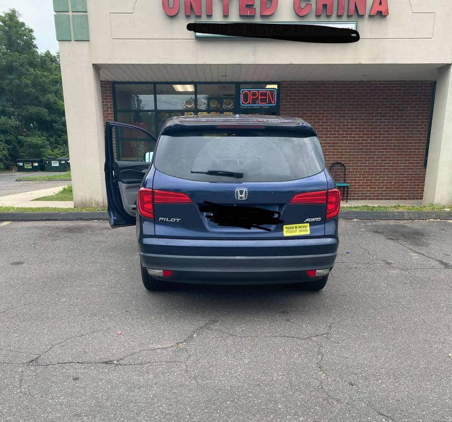 honda pilot family car with student driver magnet on back