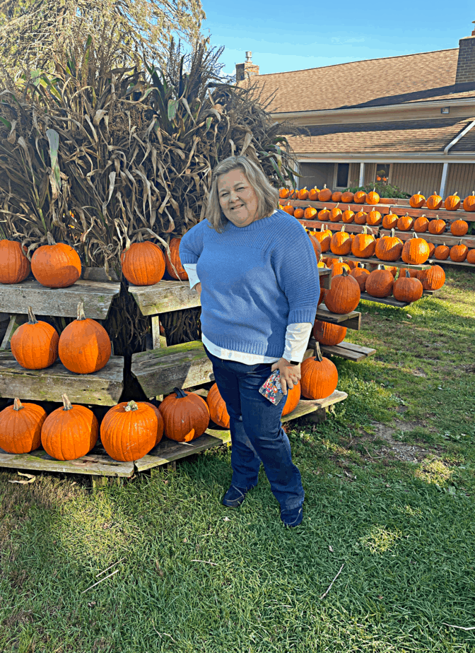 standing in front of display of pumpkins