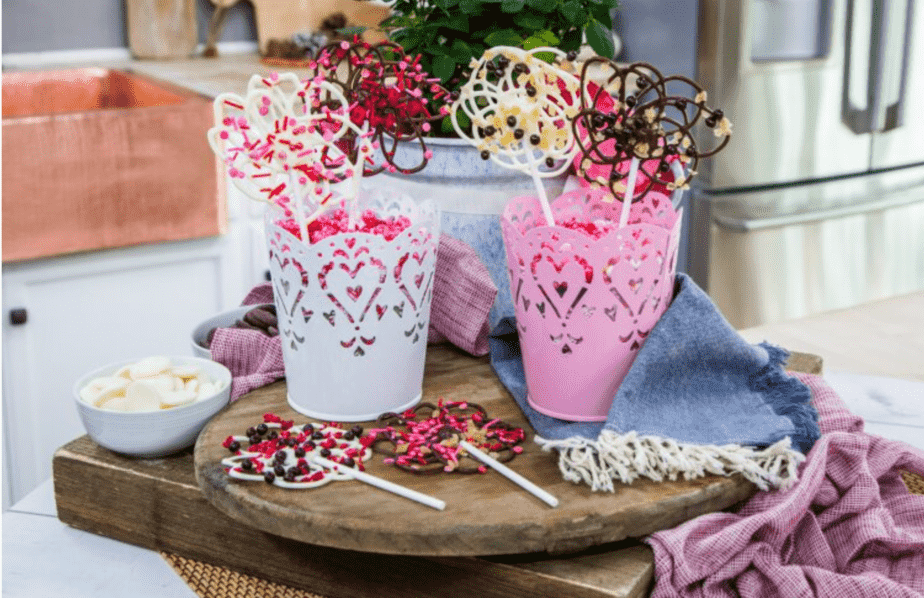 image of chocolate lace lollipops in valentine pails and on wood board