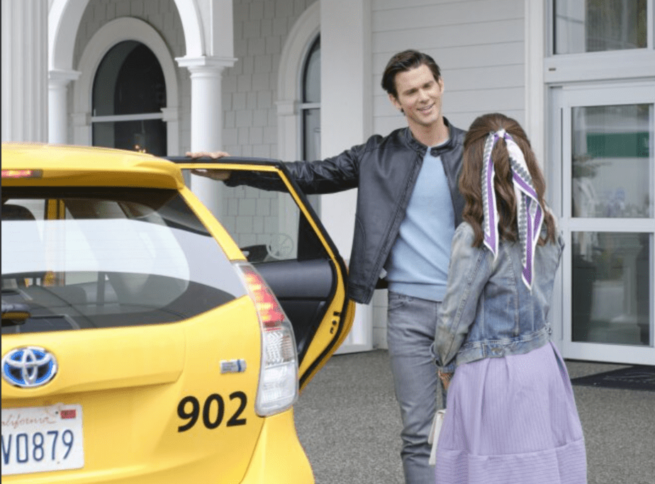 still shot from the wedding veil movie with man holding cab door open for woman