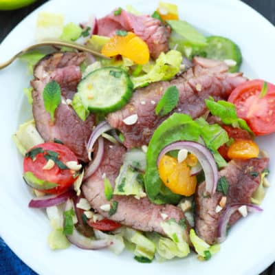 overhead shot of thai beef salad recipe served on white plate