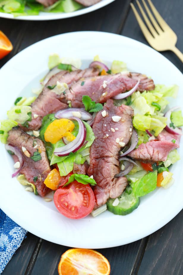 overhead view of thai beef salad served on plain white plate