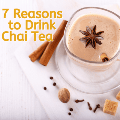 overhead view of a cup of chai tea with cinnamon sticks on a white napkin