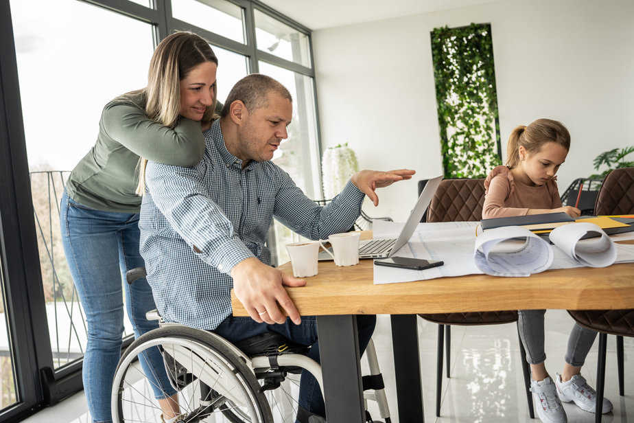 A physically challenged father works from home, supported by his family, who find moments of joy and connection amidst their daily routine.